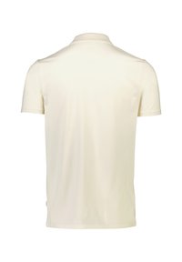 Kortärmad krämfärgad polo med klassisk krage, mjuk textur och en diskret logotypdetalj nära sömmen bak.