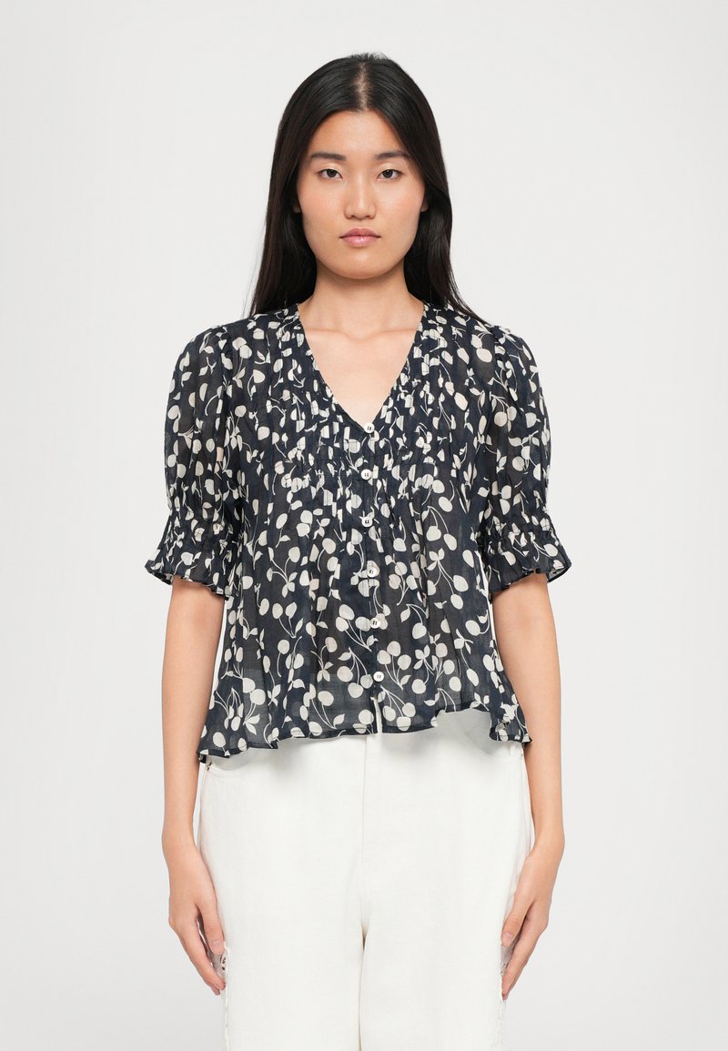 Marinebluse mit weißem Blumenmuster, Puffärmeln, V-Ausschnitt und Knopfverschluss. Hergestellt aus leichtem, halbtransparentem Stoff. Fließendes Design.