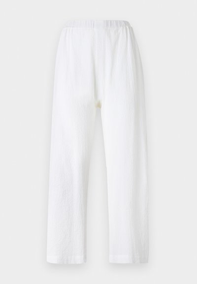 White, loose-fitting pants with an elastic waistband, made of textured fabric. Straight leg design with simple hemmed cuffs.