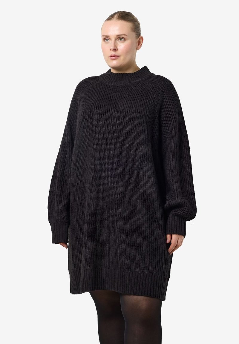 Μαύρο πλεκτό φόρεμα-πουλόβερ με ψηλό λαιμό, κάτω ώμους και ριμπ μανίκια. Διαθέτει υφή υφάσματος και υπερμεγέθη γραμμή.