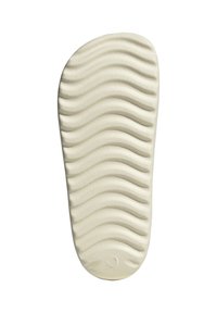 Sottopiede con una trama ondulata, realizzato in materiale foam beige chiaro, con una base piatta e bordi arrotondati per comfort e supporto.