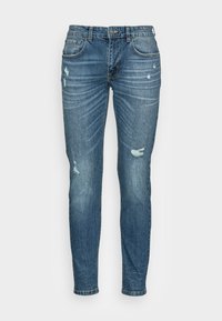 Calças skinny de ganga azul com um efeito desbotado, detalhes desgastados e leve desgaste. Apresenta cinco bolsos e fecho com botão.