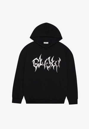 Juoda kapišonas su priekinėmis kišenėmis, turintis sidabrinį grafikos dizainą su aštriomis briaunomis. Pagamintas iš minkštos medžiagos su tekstūruota apdaila.