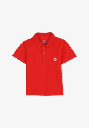 Polo rouge avec col, patte de boutonnage à trois boutons et petit logo blanc sur la poitrine gauche. Confectionné en tissu coton texturé.