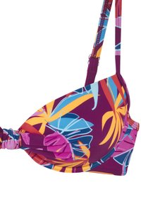 Violeta peldkostīma krūšturis ar tropu ziedu rakstu zilā, rozā un dzeltenā krāsā. Gluda auduma, ar regulējamiem siksniņām, sānu mezgla detaļa.