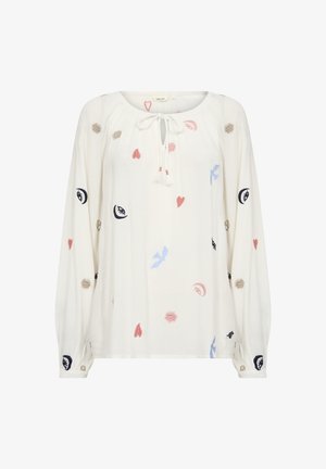 Balta bluzelė su ilgomis rankovėmis, tekstūruota medžiaga, kaklo raištelis ir spalvingas siuvinėjimas, vaizduojantis širdis, paukščius, saulių ir akių motyvus rožine, mėlyna, juoda ir bežine spalvomis.