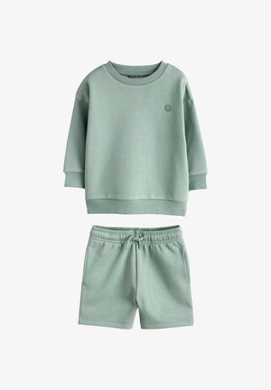 Sweat-shirt vert clair pour enfants avec emblème visage souriant et short assorti à taille élastique avec cordon, ensemble décontracté.