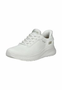 Chaussure de sport blanche en maille et en matériaux synthétiques. Présente un motif texturé, un bout rond, une semelle plate et des accents de logo décoratifs.