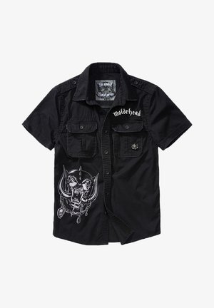Schwarzes kurzärmliges Shirt mit zwei vorderen Taschen und einem großen Grafikdruck eines Schädels mit Kette. "Motörhead"-Text auf der Brust.