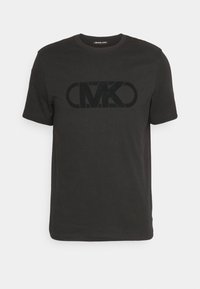 Černé bavlněné tričko s velkým, tučným černým logem "MK" ve středu. Krátké rukávy a kulatý výstřih.