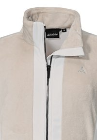 Beige fleecejacka med vita detaljer, upprätt krage, hel dragkedja och liten logotyp på bröstet. Mjuk struktur.