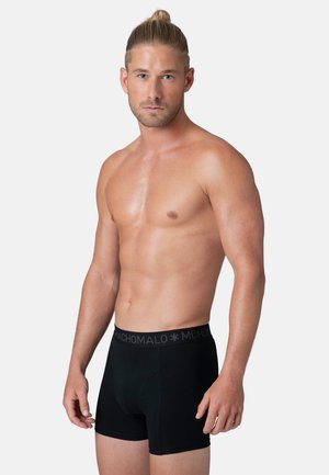 Black boxer briefs with a wide elastic waistband featuring a subtle logo. Smooth texture, fitted design, and mid-thigh length.