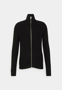 Svart ribbad zip-up-tröja med hög krage, långa ärmar och en silverfärgad dragkedja som accent. Tygets textur verkar stickad och varm.