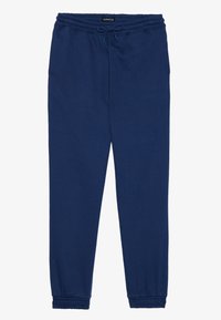 Navy blue sweatpants made of soft cotton blend, featuring an elastic waistband with drawstring and tapered cuffs at the ankles.