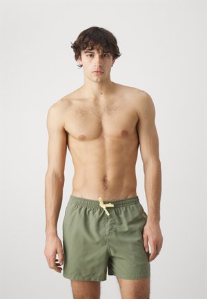 Olive green swim shorts with a drawstring in light yellow, featuring a regular fit and a smooth, lightweight fabric. No visible patterns or accents.