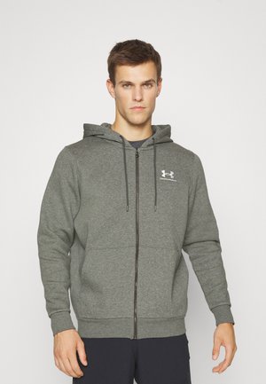 Grå zip-up hoodie med hætte, lavet af blødt stof. Har en frontlynlås, elastiske ærmer og et lille logo på brystet.