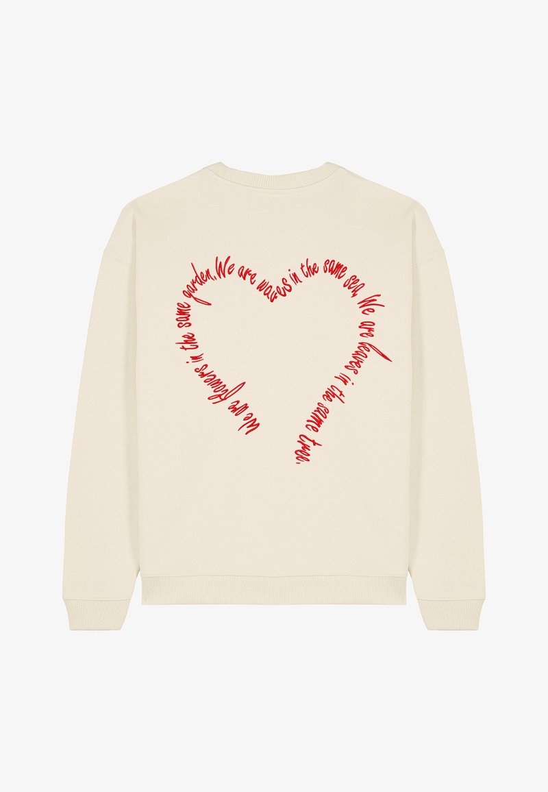 Krémová mikina s červeným srdcovým grafickým vzorom na chrbte s ručne písaným textom. Mäkký materiál, rebrované manžety a spodný lem.