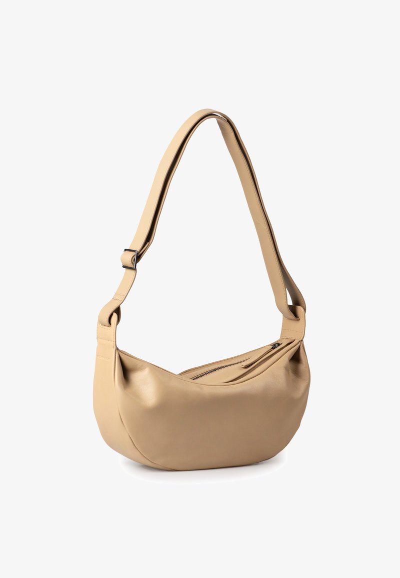 Beige leather shoulder bag with a curved shape, adjustable strap, and top zipper closure. Smooth texture with minimal hardware details.