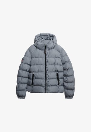 Giubbotto trapuntato grigio con cappuccio, dotato di chiusura lampo anteriore, due tasche con zip e polsini elastici. Design testurizzato e trapuntato.