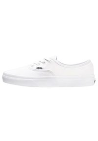 White canvas sneakers with round toe, lace-up design, and rubber sole. Features Vans logo tag on the side, smooth texture, and low-profile silhouette.