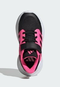 Black athletic shoe with pink accents, mesh upper, lace and strap closure, cushioned collar, and white sole with branding on the side.