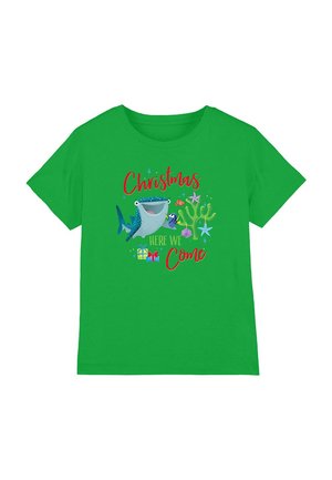 Green short-sleeve T-shirt featuring a Christmas graphic with a shark, fish, and gifts, with red text saying "Christmas Here We Come."
