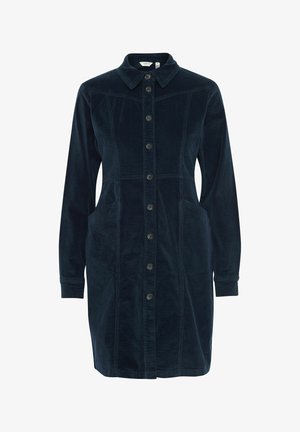 Tamno plava korduroy haljina košulja s dugim rukavima, dugmadima sprijeda, ovratnikom i dva prednja džepa. Ima strukturirani kroj s vertikalnim šavovima.