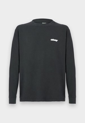 Svart langermet T-skjorte laget av bomull, med rund hals og en hvit "obey" logo på venstre bryst. Glatt tekstur, avslappet passform.