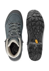 Stivali da trekking grigi in pelle con punta rinforzata, passanti in metallo, suola in gomma texturizzata e un unico logo Vibram sulla suola.