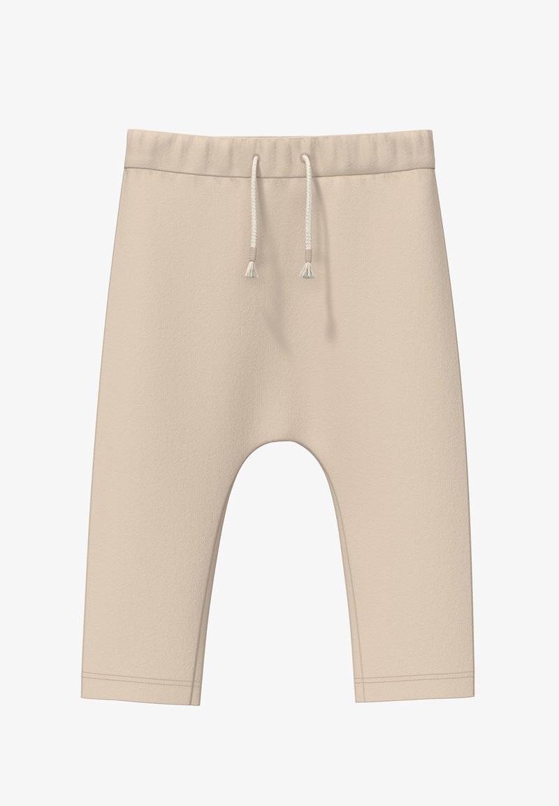 Beige, verkürzte Sweatpants aus weichem Material. Mit elastischem Bund und Kordelzug sowie einer lässigen Passform. Keine Muster oder Akzente.