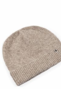 Light brown knitted beanie made from soft, fuzzy material. Features a ribbed cuff and small logo tag on the side.