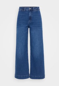 High-waisted wide-leg jeans in medium blue denim, featuring a button closure, belt loops, and a clean hem with no distressing.
