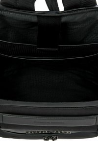 Black backpack with a textured exterior, featuring a zip closure, interior pockets, and the brand name embossed on a leather accent.