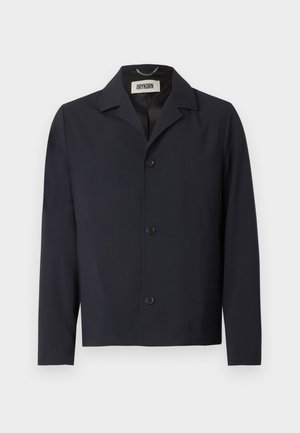 Black button-up jacket with pointed collar, long sleeves, and brand label "DRYKORN" inside the neckline.