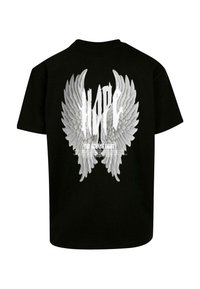 Sort bomulds T-shirt med store hvide englevinger grafik og ordet "HOPE" ovenfor, samt yderligere tekst under designet.