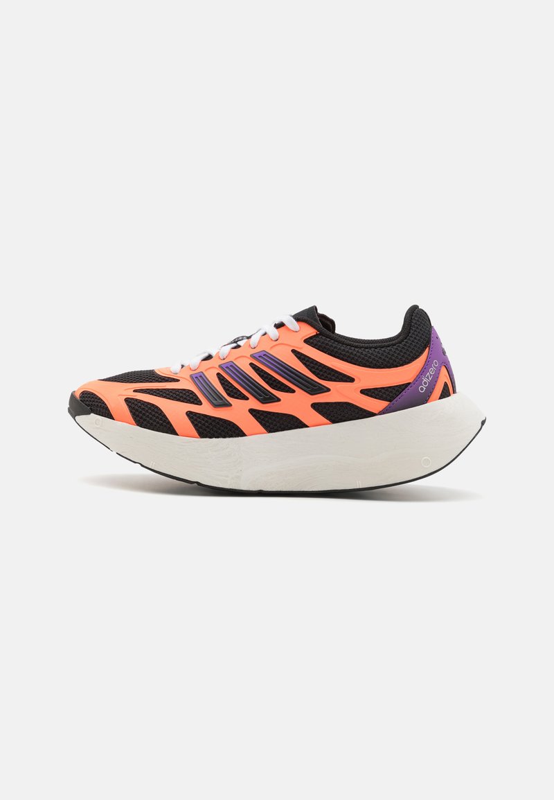 Black and orange athletic shoe with a mesh upper, contrasting purple accents, and a white cushioned sole. Features angular cutouts in design.