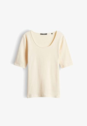 Cream ribbed short-sleeve top with scoop neckline, laid flat on white background.