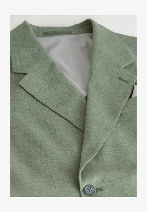 Sacou verde deschis dintr-un material texturat, cu rever decupat, închidere cu un singur nasture și căptușeală interioară gri.