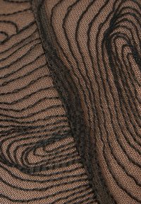 Black mesh fabric featuring a wavy pattern with textured lines on a brown base, showcasing a sheer and layered design.