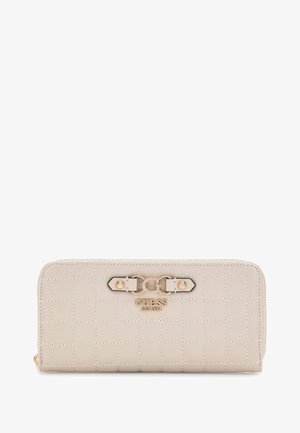 Beige quilted leather zip-around wallet with gold-tone buckle detail and "GUESS EST 1981" logo on front.