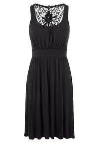 Schwarzes ärmelloses Kleid, weicher Stoff, tailliert, ausgestellt Rock, Spitzenverzierung am Rücken, runder Ausschnitt. Die Länge reicht bis über die Knie.