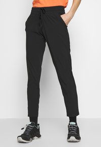 Svarta träningsbyxor med dragband i midjan, smalare ben, sidofickor och en mjuk, lätt tygkvalitet.