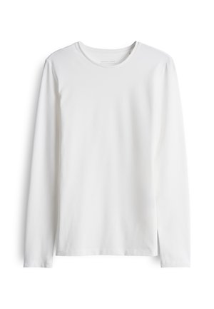 T-shirt bianca a maniche lunghe realizzata in cotone morbido. Presenta una scollatura rotonda e un taglio dritto con cuciture minime e senza loghi o motivi visibili.
