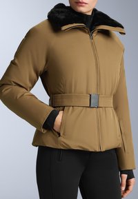 Brown padded jacket with a black faux fur collar, zip closure, belted waist, and side pockets. Textured sleeves and a sleek design.