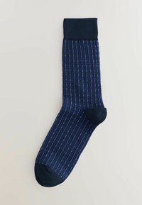 Navy blue sock with a small blue and black geometric pattern, ribbed cuff, reinforced heel, and toe on a light background.
