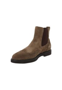 Bottines Chelsea en suede marron avec des détails en brogue, des panneaux latéraux en élasthanne et une semelle en caoutchouc noir.