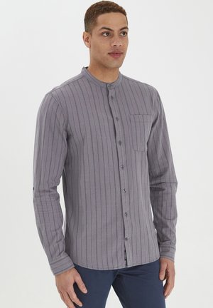 Gray long-sleeve shirt with vertical stripes, button closure, and a chest pocket. Made of textured fabric, featuring a classic collar.