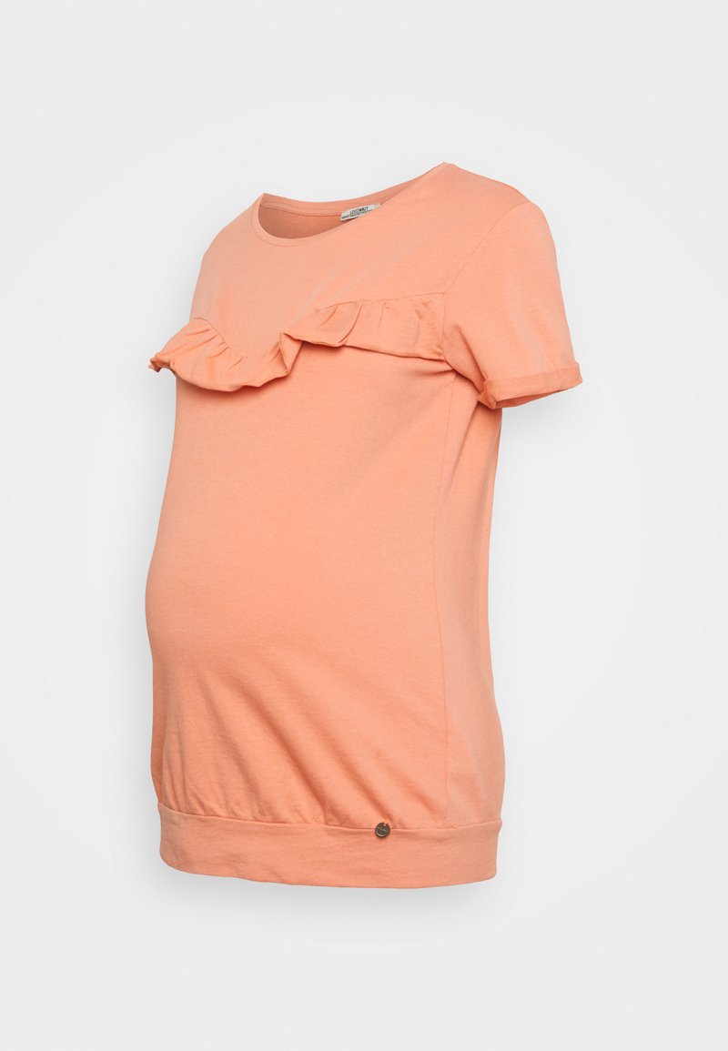 T-shirt de maternidade em cor pêssego, com mangas curtas, apresenta um detalhe franzido na decote, feita de algodão suave, com uma bainha curvada.