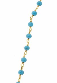 Collana di perline turchesi con elementi in metallo dorato, caratterizzata da perle rotonde e lisce disposte in un motivo simmetrico.