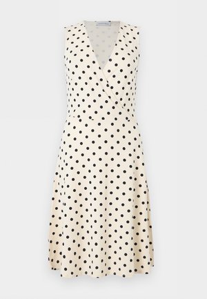 Obleka brez rokavov kremne barve s črnimi pikami, V-izrez v stilu ovoja in krilo v obliki črke A do kolen.